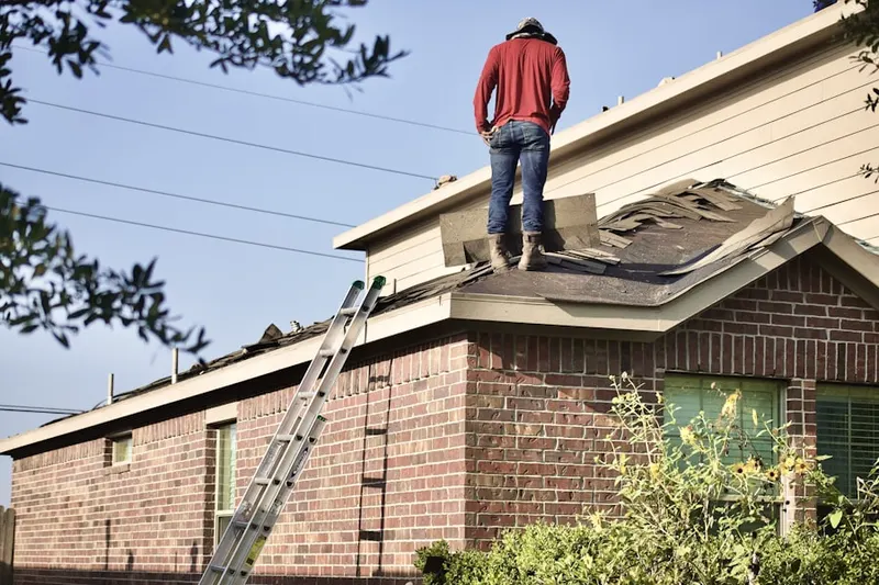 Professional roofer working on a residential roof in Pekin